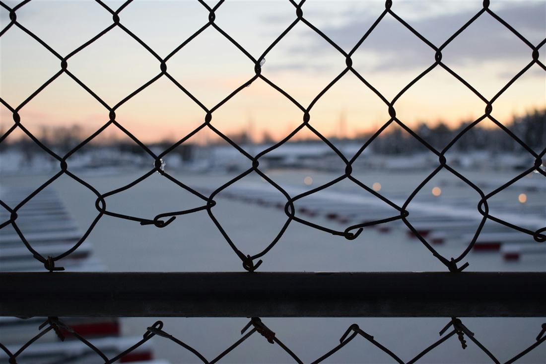 Airside perimeter fencing along a controlled airport boundary.